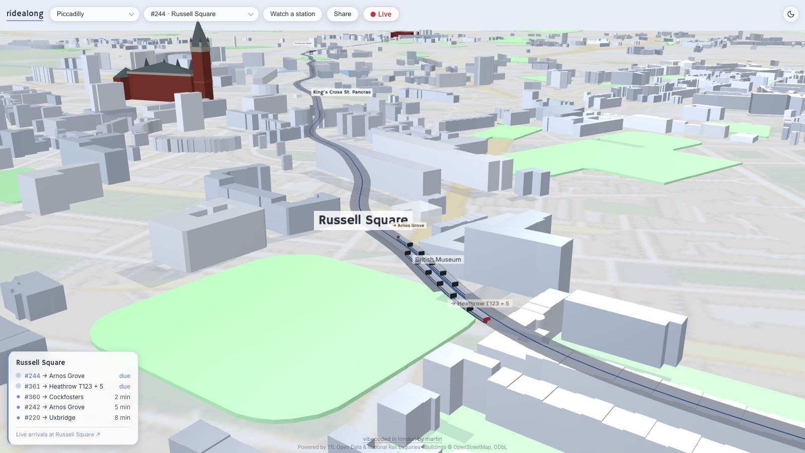 ridealong's chase-cam mid-ride in the pale day theme — a boarded Piccadilly line train at Russell Square with an oncoming Heathrow train below it, St Pancras in red behind, and a live arrivals panel in the corner.